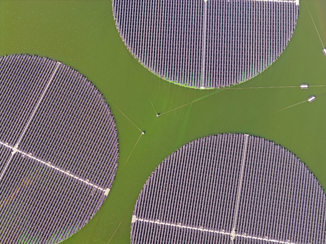 Aerial view of three circular floating solar islands on green water in Andijk Noord Holland Netherlands. Aerial view of three circular floating solar islands on green water in Andijk Noord Holland Netherlands.