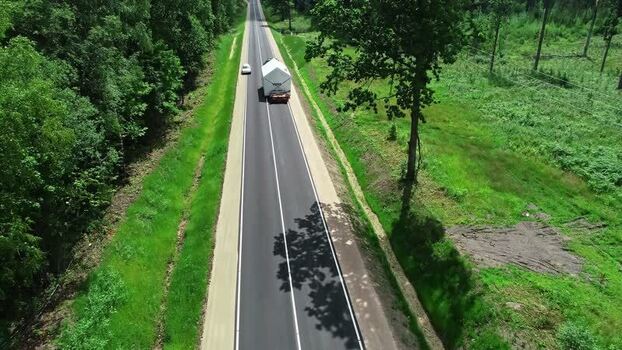 Aerial view of truck transporting modular structure Latvia.