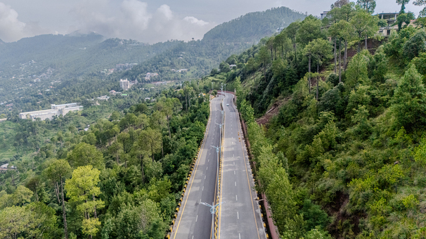 Aerial view of the Islamabad Murree Expressway winding through lush green hills and dense forests in Lower Topa Punjab Pakistan. Aerial view of the Islamabad Murree Expressway winding through lush green hills and dense forests in Lower Topa Punjab Pakistan.