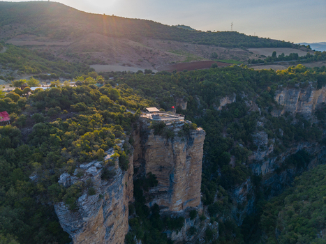 Aerial view of Osumi canyon with its dramatic limestone cliffs and lush green vegetation under the warm light of the golden hour in Dhores Berat County Albania.