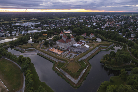 Aerial view of Kuressaare Castle a medieval fortress surrounded by moats and parkland with the town of Kuressaare in the background at sunset in Kuressaare Saare County Estonia.
