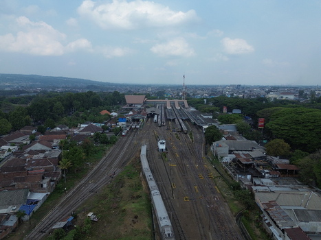 Aerial view of Stasiun Malang Kota Baru with train tracks platforms and surrounding urban landscape in Kecamatan Klojen Jawa Timur Indonesia.
