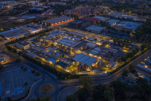 Aerial view of an industrial facility illuminated at night featuring complex machinery storage tanks and surrounding infrastructure in Settecamini Lazio Italy.