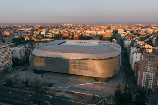 Aerial view of Santiago Bernabeu stadium with its modern metallic facade surrounded by urban buildings and streets in Madrid Community of Madrid Spain. Aerial view of Santiago Bernabeu stadium with its modern metallic facade surrounded by urban buildings and streets in Madrid Community of Madrid Spain.