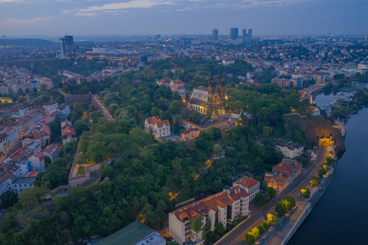 Aerial view of the historic Vysehrad fortress and the Basilica of St Peter and St Paul surrounded by lush greenery and the Vltava river at dusk in Prague Prague Czechia.