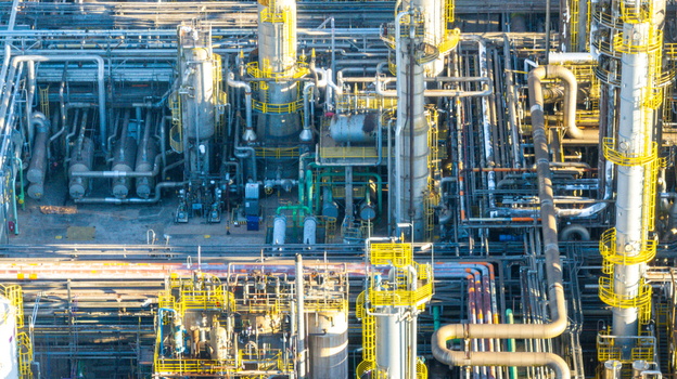 Aerial view of the petrochemical complex featuring intricate networks of industrial pipes distillation towers and storage tanks. Santo Andre State of Sao Paulo Brazil.