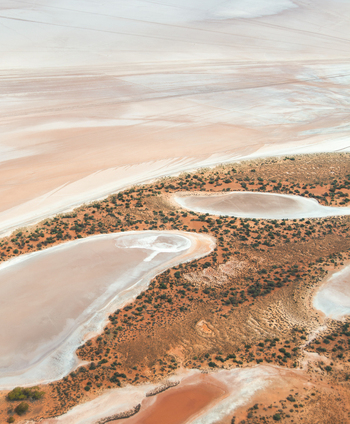Aerial view of abstract minimal pink salt lake textures and outback orange colours on Lake Lefroy Western Australia