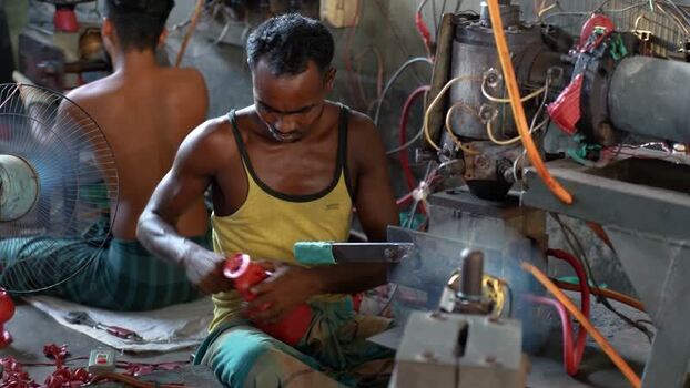 View of a worker in a factory in Bogura Bangladesh. View of a worker in a factory in Bogura Bangladesh.