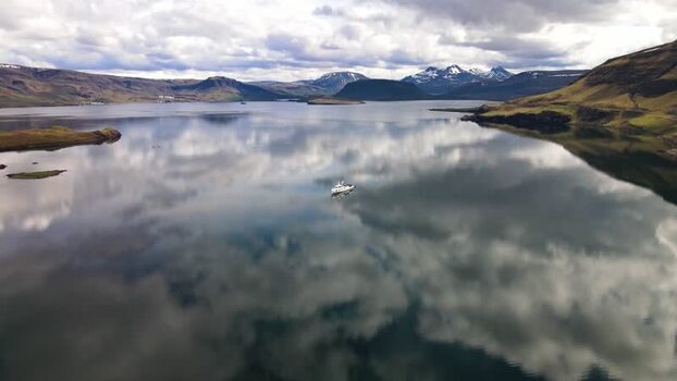 Aerial view of a boat on the calm waters of Hvalfjordur Iceland. Aerial view of a boat on the calm waters of Hvalfjordur Iceland.