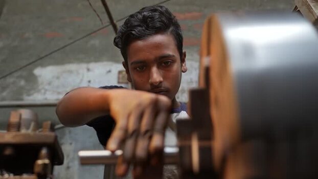 View of a young worker operating a lathe in Bogura Bangladesh.
