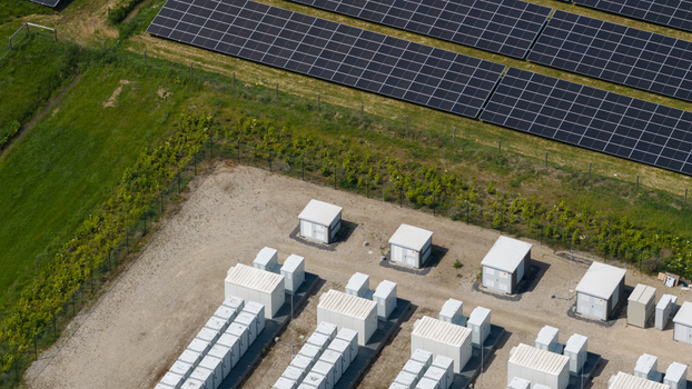 Aerial view of a solar farm with rows of photovoltaic panels and battery storage units in Wanneperveen Overijssel Netherlands.