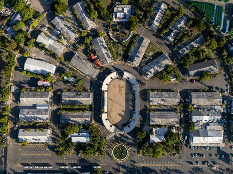 Aerial view of a circular stadium surrounded by radial buildings and parking lots in Santo Domingo Distrito Nacional Dominican Republic. Aerial view of a circular stadium surrounded by radial buildings and parking lots in Santo Domingo Distrito Nacional Dominican Republic.