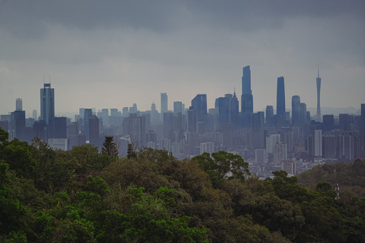 Aerial view of the Guangzhou skyline featuring modern skyscrapers and the Canton Tower under a cloudy sky in Guangzhou Guangdong Province China. Aerial view of the Guangzhou skyline featuring modern skyscrapers and the Canton Tower under a cloudy sky in Guangzhou Guangdong Province China.