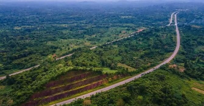 Aerial view of a highway winding through a lush green forested landscape in Ghana. Aerial view of a highway winding through a lush green forested landscape in Ghana.