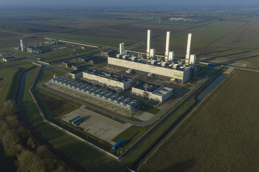 Aerial view of the nitrogen plant facility with tall white chimneys and industrial buildings surrounded by green fields Zuidbroek Groningen Netherlands. Aerial view of the nitrogen plant facility with tall white chimneys and industrial buildings surrounded by green fields Zuidbroek Groningen Netherlands.