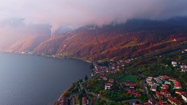 Aerial view of a lakeside village at sunset Italy.