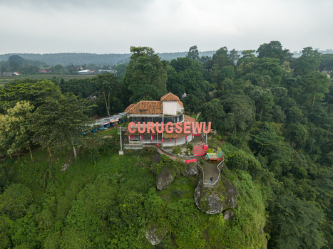 Aerial view of the Curugsewu landmark perched atop a verdant hill a striking contrast against the dense foliage Kendal Regency Central Java Indonesia. Aerial view of the Curugsewu landmark perched atop a verdant hill a striking contrast against the dense foliage Kendal Regency Central Java Indonesia.