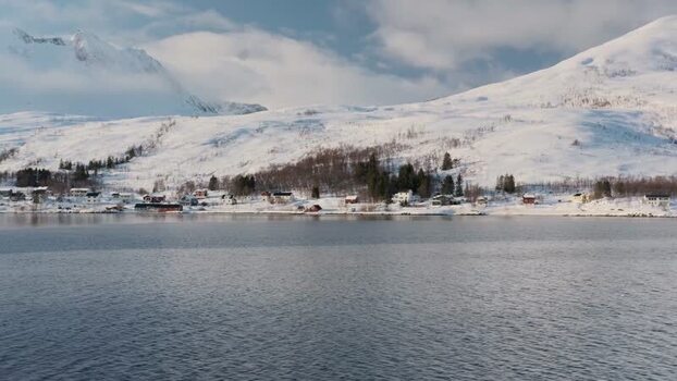 View of Botnhamn village and snowy mountains Norway.