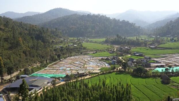 View of terraced fields and a village in a valley Nepal.