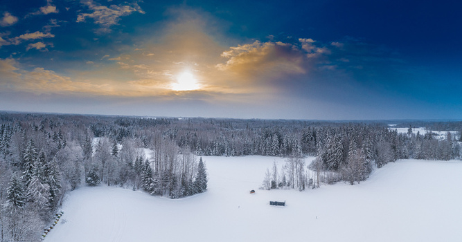 Aerial view of a snow covered forest and fields in Latvia. Aerial view of a snow covered forest and fields in Latvia.