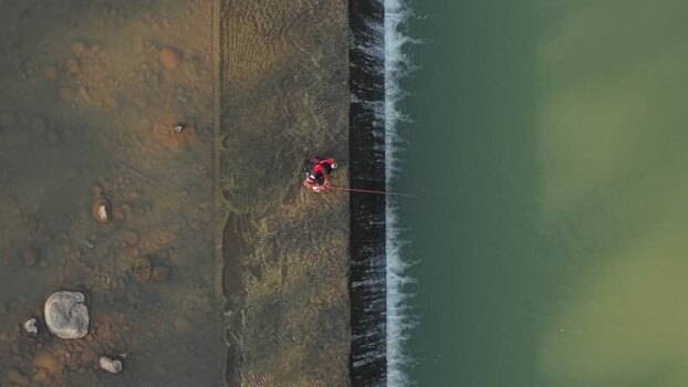 Aerial view of a fisherman at Tangsi River Water Gate Indonesia. Aerial view of a fisherman at Tangsi River Water Gate Indonesia.