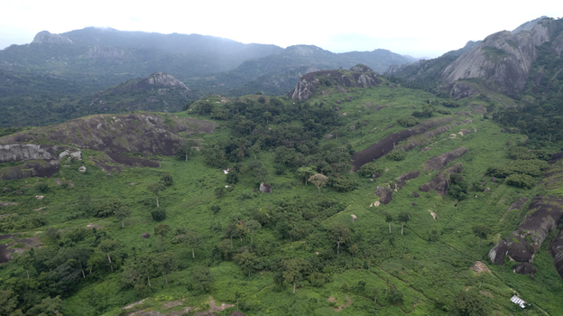 Aerial view of Idanre Hill featuring lush green vegetation and dramatic rocky outcrops in the mountainous landscape of Idanre Ondo State Nigeria. Aerial view of Idanre Hill featuring lush green vegetation and dramatic rocky outcrops in the mountainous landscape of Idanre Ondo State Nigeria.