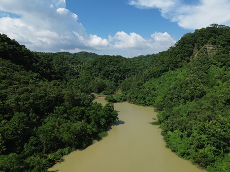 Aerial view of the winding river flowing through the lush green hills of Sitakund Chittagong Division Bangladesh. Aerial view of the winding river flowing through the lush green hills of Sitakund Chittagong Division Bangladesh.