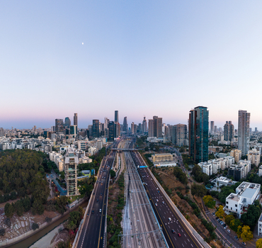 Aerial view of the Tel Aviv skyline featuring modern skyscrapers a busy highway and railway tracks running through the urban landscape in Tel Aviv Yafo Tel Aviv District Israel. Aerial view of the Tel Aviv skyline featuring modern skyscrapers a busy highway and railway tracks running through the urban landscape in Tel Aviv Yafo Tel Aviv District Israel.