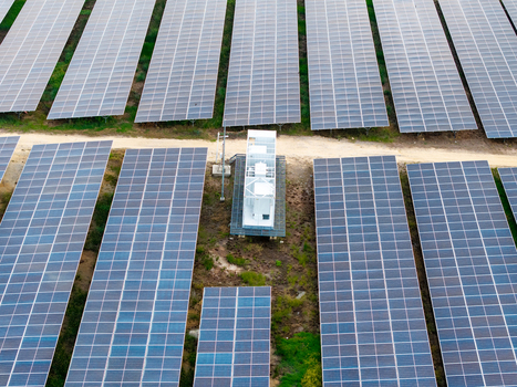 Aerial view of a large scale solar photovoltaic power plant with rows of solar panels and a central electrical substation in Central Seberang Perai Penang Malaysia. Aerial view of a large scale solar photovoltaic power plant with rows of solar panels and a central electrical substation in Central Seberang Perai Penang Malaysia.