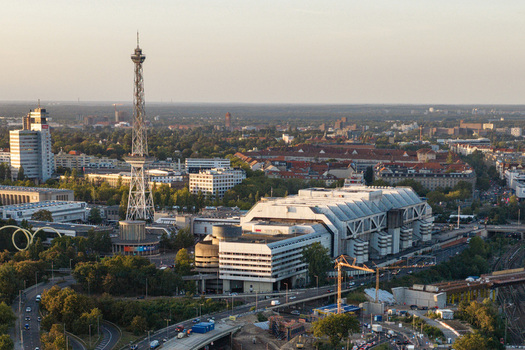 Aerial view of the Internationales Congress Centrum and the iconic Funkturm radio tower surrounded by urban greenery and city infrastructure in Berlin Berlin Germany. Aerial view of the Internationales Congress Centrum and the iconic Funkturm radio tower surrounded by urban greenery and city infrastructure in Berlin Berlin Germany.
