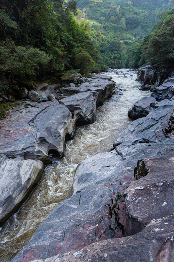 View of the Estrecho del Rio Magdalena a narrow gorge where the river flows through dramatic rock formations surrounded by lush green forest in San Agustin Huila Colombia.