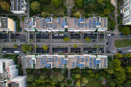 Aerial view of High Deck Siedlung featuring residential buildings with solar panels on rooftops surrounded by green spaces and streets in Berlin Berlin Germany. Aerial view of High Deck Siedlung featuring residential buildings with solar panels on rooftops surrounded by green spaces and streets in Berlin Berlin Germany.