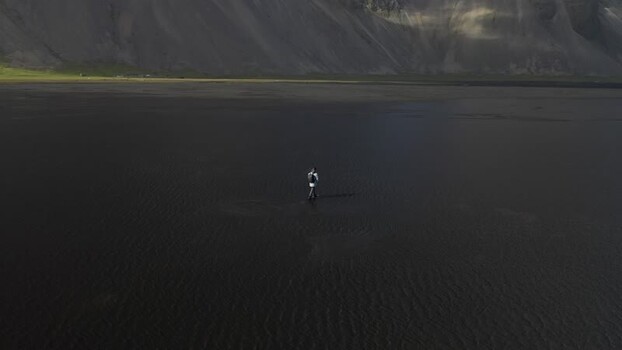 Aerial view of a person on the black sand beach of Stokksnes ICELAND.