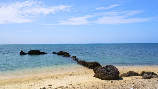 View of the rocky coastline and clear blue waters of Shiraho Beach on Ishigaki Island Ishigaki Okinawa Japan.