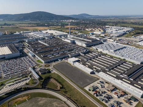 Aerial view of the Volkswagen Slovakia factory in Devinska Nova Ves featuring large industrial halls parking lots with new cars and a tall chimney Bratislava Bratislavsky kraj Slovakia. Aerial view of the Volkswagen Slovakia factory in Devinska Nova Ves featuring large industrial halls parking lots with new cars and a tall chimney Bratislava Bratislavsky kraj Slovakia.