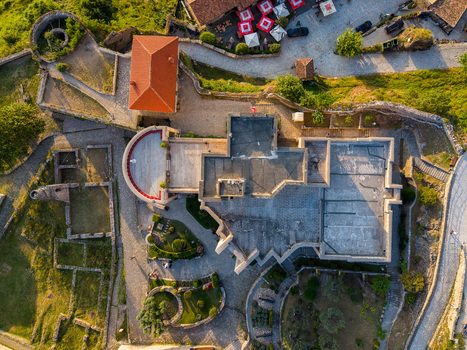 Aerial view of the historic Kruje Castle featuring ancient stone fortifications ruins and an orange tiled roof in Kruje Durres County Albania.