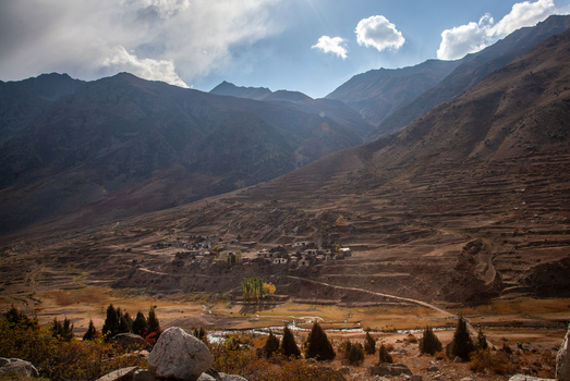 View of Astore Valley featuring a small village nestled among terraced fields and rugged mountain slopes under a clear blue sky in Astore Gilgit Pakistan. View of Astore Valley featuring a small village nestled among terraced fields and rugged mountain slopes under a clear blue sky in Astore Gilgit Pakistan.