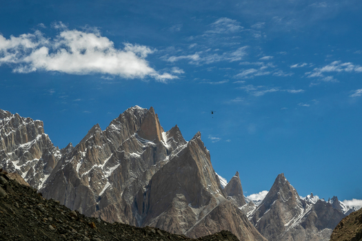 View of the Trango Towers in the Karakoram mountain range with snow capped peaks rocky slopes and a clear blue sky Pakistan. View of the Trango Towers in the Karakoram mountain range with snow capped peaks rocky slopes and a clear blue sky Pakistan.