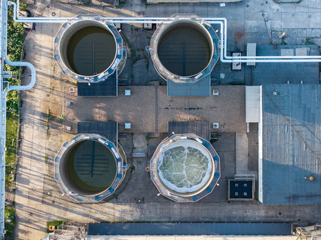 Aerial view of the Heizkraftwerk Klingenberg combined heat and power plant featuring four large circular industrial tanks one with bubbling water in Berlin Berlin Germany. Aerial view of the Heizkraftwerk Klingenberg combined heat and power plant featuring four large circular industrial tanks one with bubbling water in Berlin Berlin Germany.