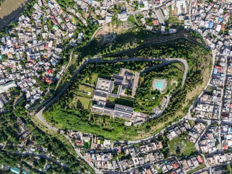 Aerial view of the historic Red Fort surrounded by lush greenery and the dense urban landscape of Muzaffarabad Azad Kashmir Pakistan. Aerial view of the historic Red Fort surrounded by lush greenery and the dense urban landscape of Muzaffarabad Azad Kashmir Pakistan.