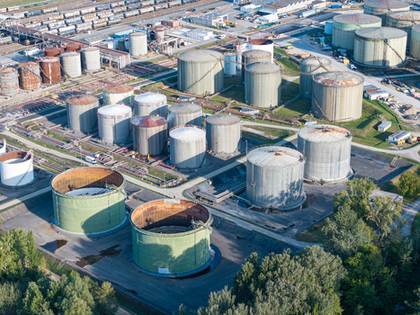 Aerial view of Cressier Refinery featuring numerous large industrial storage tanks complex pipeline networks and adjacent railway tracks in a rural setting Cornaux Neuchatel Switzerland. Aerial view of Cressier Refinery featuring numerous large industrial storage tanks complex pipeline networks and adjacent railway tracks in a rural setting Cornaux Neuchatel Switzerland.