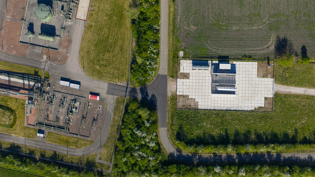 Aerial view of industrial facility and utility infrastructure surrounded by green fields and trees near Erflanden in Hoogeveen Drenthe Netherlands.