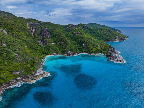 Aerial view of the turquoise waters meeting the lush green coastline a symphony of nature s vibrant hues Vista do Mar Mahe Island Seychelles. Aerial view of the turquoise waters meeting the lush green coastline a symphony of nature s vibrant hues Vista do Mar Mahe Island Seychelles.