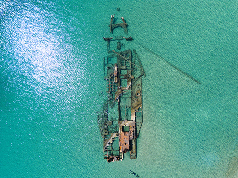 Aerial view of the rusted Shipwreck Epanomi resting in clear turquoise waters over a sandy seabed Epanomi Greece.