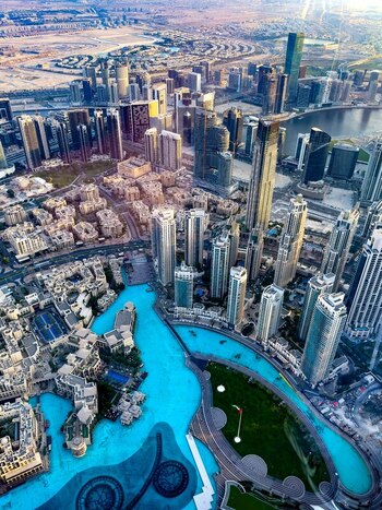 Aerial view of the modern skyscrapers and the iconic Burj Khalifa area with its turquoise fountains and urban landscape in Dubai Dubai United Arab Emirates. Aerial view of the modern skyscrapers and the iconic Burj Khalifa area with its turquoise fountains and urban landscape in Dubai Dubai United Arab Emirates.