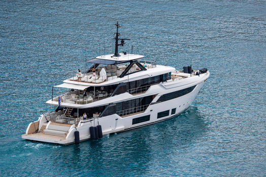 Aerial view of a luxury white yacht cruising on the blue Mediterranean sea with people relaxing on the deck Nice Provence Alpes Cote d Azur France. Aerial view of a luxury white yacht cruising on the blue Mediterranean sea with people relaxing on the deck Nice Provence Alpes Cote d Azur France.