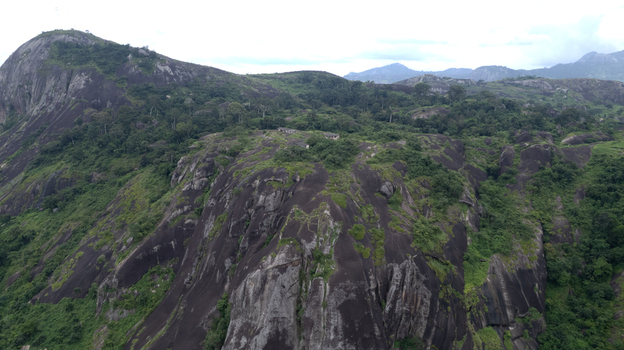 Aerial view of Idanre Hill featuring massive granite rock formations and lush green vegetation in Idanre Ondo State Nigeria. Aerial view of Idanre Hill featuring massive granite rock formations and lush green vegetation in Idanre Ondo State Nigeria.