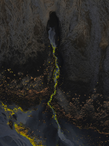 Aerial view of a vibrant green stream cutting through dark rugged terrain creating a striking contrast of nature s artistry Iceland. Aerial view of a vibrant green stream cutting through dark rugged terrain creating a striking contrast of nature s artistry Iceland.