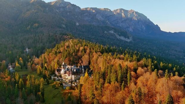 Aerial view of Peles Castle in autumn forest Romania. Aerial view of Peles Castle in autumn forest Romania.
