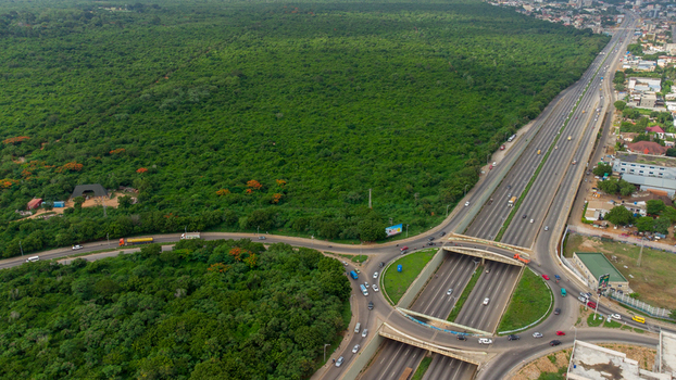 Accra Greater Accra Region Ghana 02 June 2023 Aerial view of the Forever roundabout with surrounding dense forest and highway traffic.